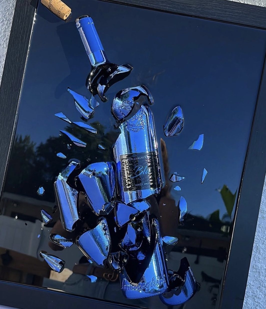 A cobalt blue bottle shattered and preserved by hand into blue, framed as one of one wall art